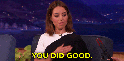 Gif of Aubrey Plaza patting her own back.