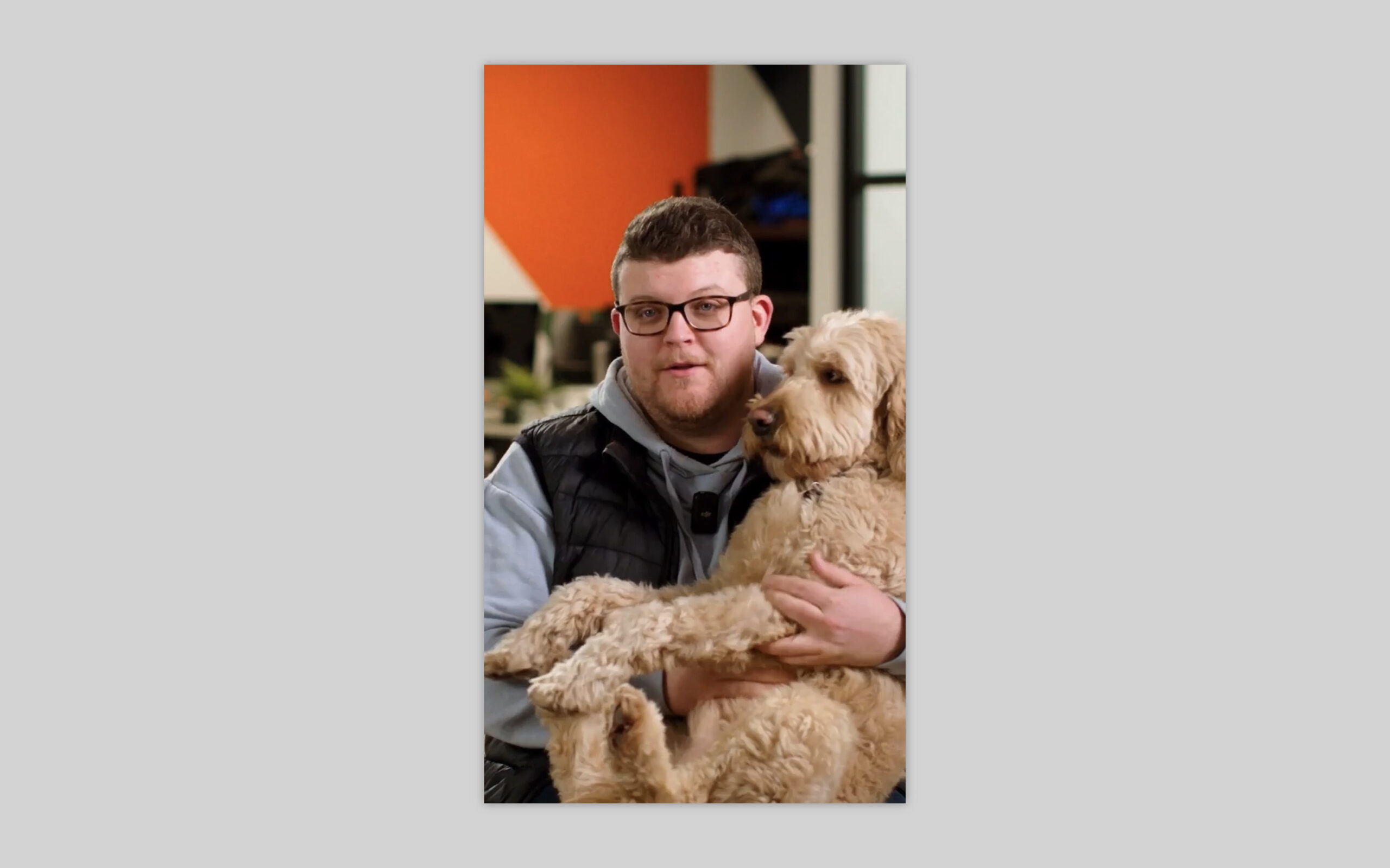 A screenshot from our shoot of Brandon with his dog in his lap.